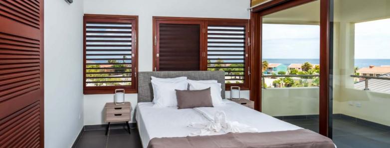 A spacious bedroom in a penthouse at Delfins Beach Resort Bonaire.