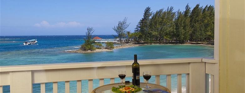 A balcony with an ocean view at Fantasy Island Roatan Resort.