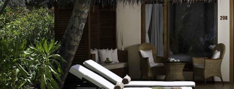 Lounge chairs on a deluxe beach villa deck at Kuramathi Island Resort Maldives.