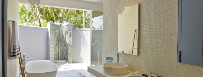 A modern bathroom in a two bedroom beach house at Kuramathi Island Resort Maldives.