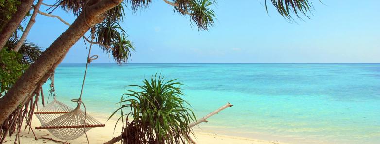 A white sand beach and turquoise sea at Lankayan Island Resort