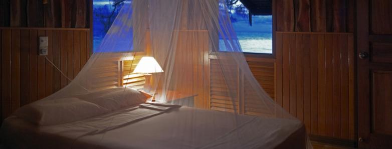 A bed in a chalet at Lankayan Island Resort