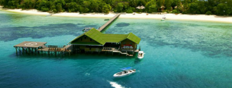 Lankayan Island Resort stretching over the sea from the white sand beach