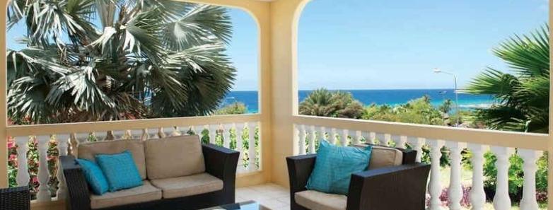 Sofa and chairs on a standard villa balcony at Livingstone Jan Thiel Beach Resort
