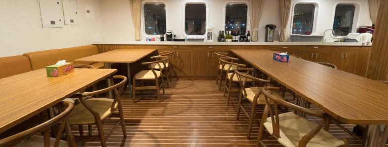 The indoor dining area on the White Manta liveaboard