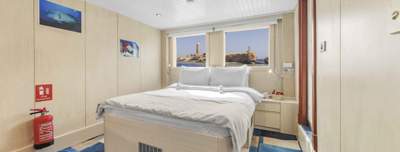 A double bed in a cabin on the Royal Evolution liveaboard in the Red Sea.