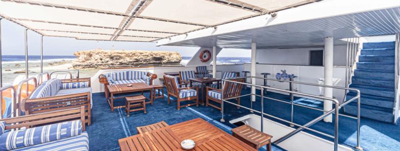 An outdoor lounge area on the Royal Evolution liveaboard in the Red Sea.