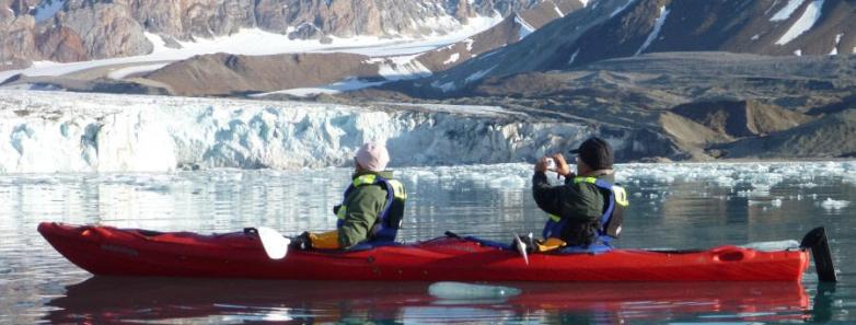 Two people kayak in the arctic