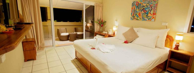 A deluxe room with a large bed at The Espiritu Vanuatu.