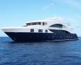 A luxurious yacht, the MV Emperor Serenity Liveaboard, sailing gracefully in the vast ocean of the Maldives.