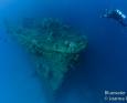 Scuba diver photographing a ship wreck underwater in truk lagoon micronesia
